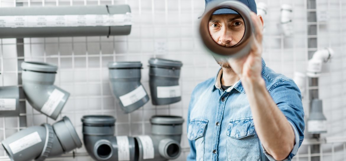 Man choosing pipes in the plumbing shop Man choosing pipes in the plumbing shop