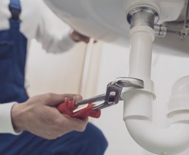 Plumber fixing a sink at home
